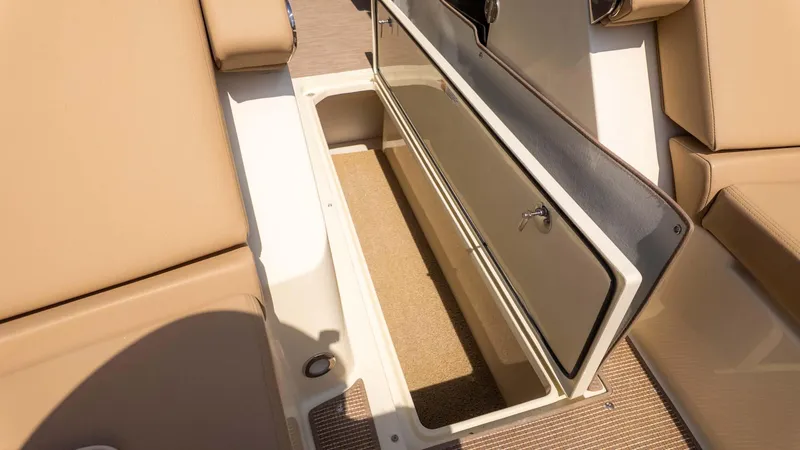 Slide: The Image of 2025 Chris-Craft Launch 28 GT storage compartment with beige seating and open hatch. - 25