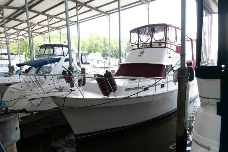 The Image of 1988 Mainship 36 Double Cabin yacht docked in a covered marina. - 0