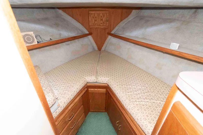 Slide: The Image of 1988 Mainship 36 Double Cabin interior with twin beds and wooden cabinetry. - 12