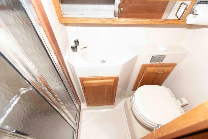 Slide: The Image of Compact bathroom in 1988 Mainship 36 Double Cabin with shower, sink, and toilet. - 13