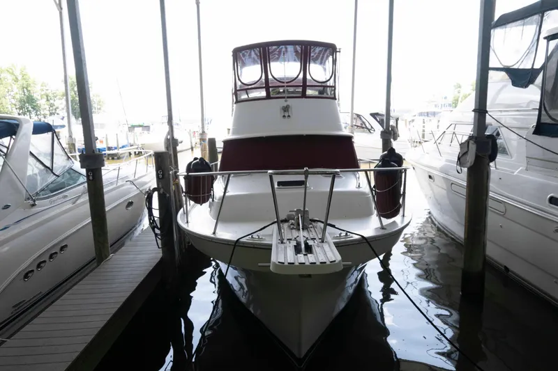 Slide: The Image of 1988 Mainship 36 Double Cabin yacht docked in marina, front view. - 2