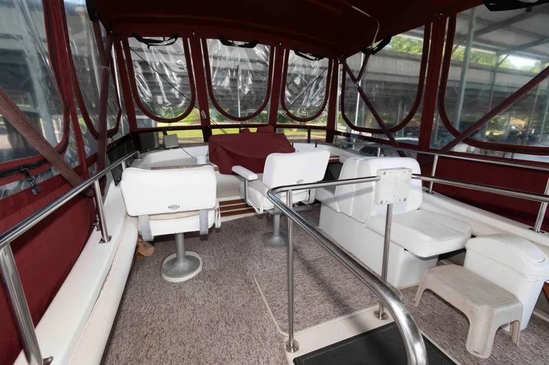 Slide: The Image of 1988 Mainship 36 Double Cabin interior with red canopy and white seating. - 3