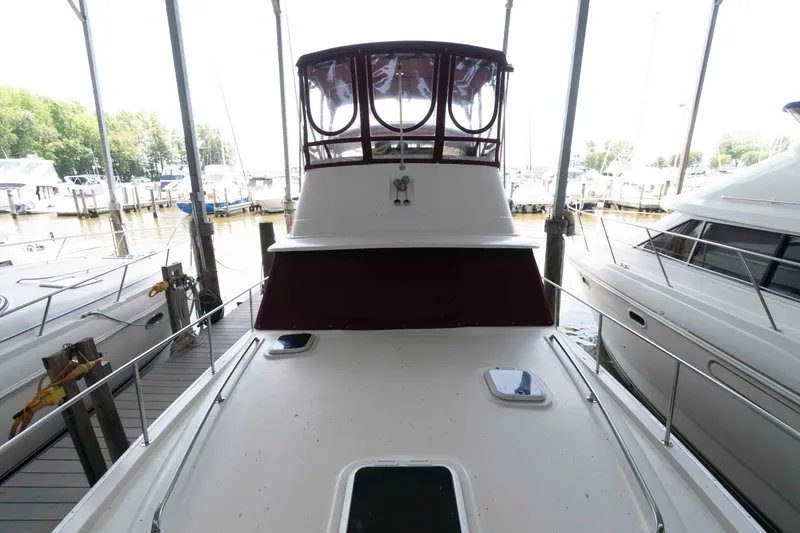 Slide: The Image of 1988 Mainship 36 Double Cabin yacht docked at marina, view from bow. - 5