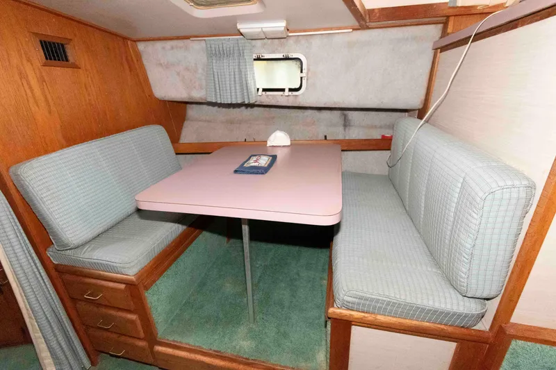 Slide: The Image of 1988 Mainship 36 Double Cabin interior with cozy dinette and cushioned seating. - 9