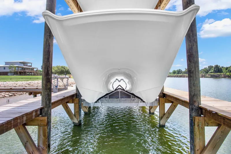 Slide: The Image of Freeman 47 boat docked, 2022 model, viewed from below on a sunny day. - 30