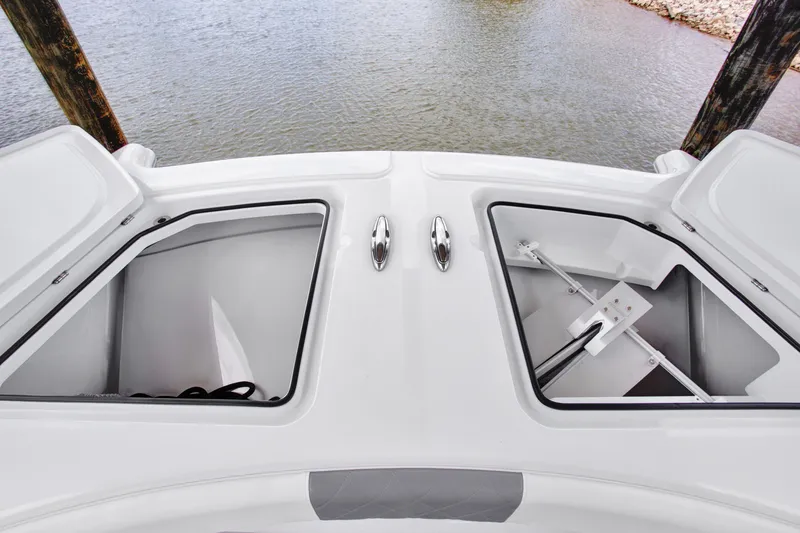 Slide: The Image of Open storage compartments on a 2022 Freeman 47 boat, docked by the water. - 43