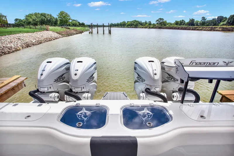 Slide: The Image of Freeman 47 boat with Yamaha engines on a serene river, 2022 model. - 48