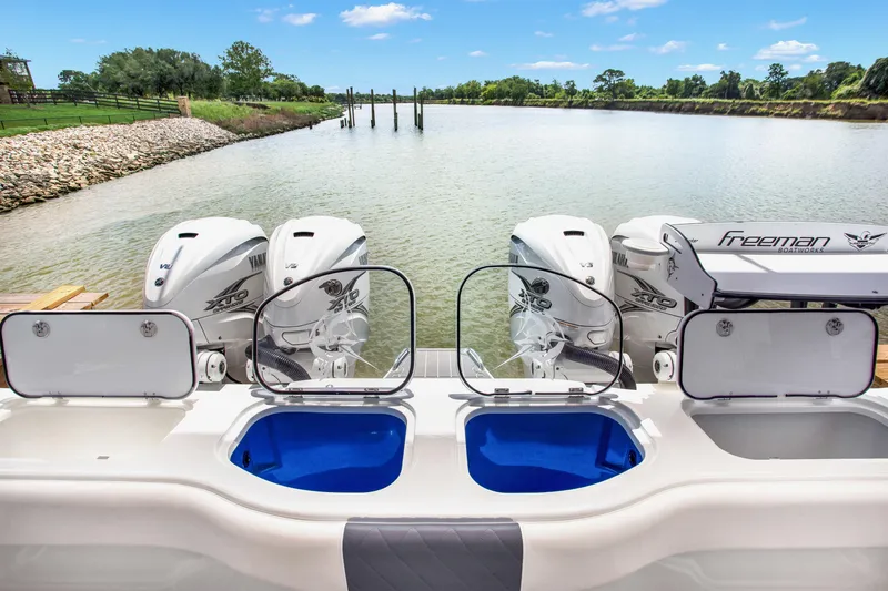 Slide: The Image of Freeman 47 boat with Yamaha engines on a serene river, 2022 model. - 49