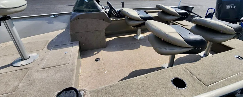 Slide: The Image of 2003 Lund 1675 Explorer SS boat interior with seating and console, featuring Yamaha 80 engine. - 2