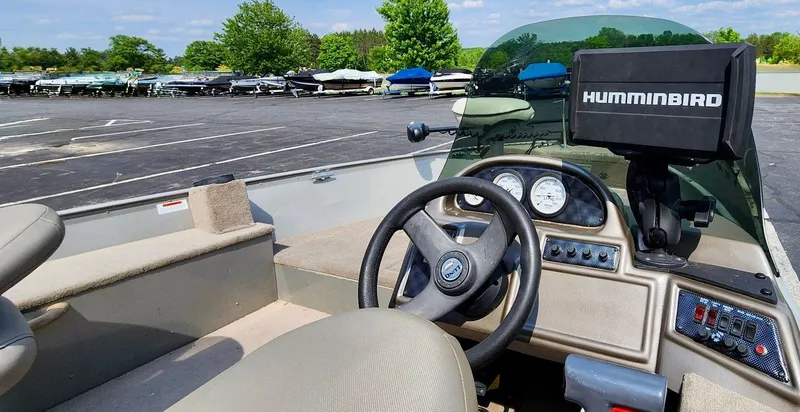 Slide: The Image of 2003 Lund 1675 Explorer SS boat interior with steering wheel and Humminbird fish finder. - 5