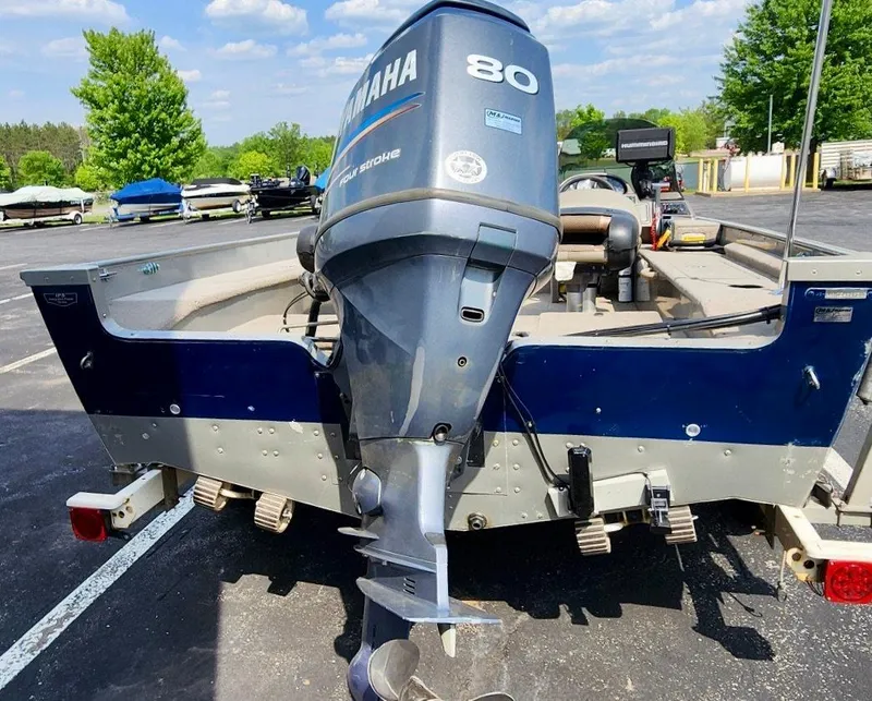 Slide: The Image of 2003 Lund 1675 Explorer SS boat with Yamaha 80 outboard motor in a parking lot. - 6