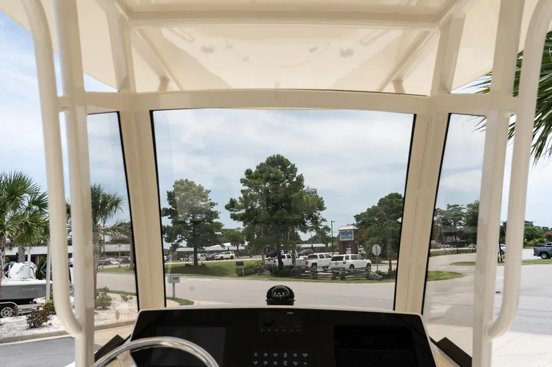 Slide: The Image of View from the helm of a 2026 Scout 215 XSF boat, showcasing a marina. - 11