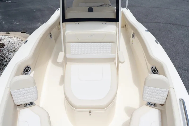 Slide: The Image of 2026 Scout 215 XSF boat interior with white cushioned seating and sleek design. - 14