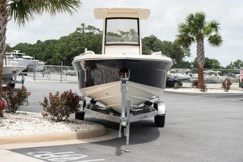 Slide: The Image of 2026 Scout 215 XSF boat on trailer in parking lot with palm trees. - 3