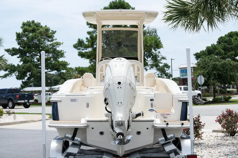 Slide: The Image of 2026 Scout 215 XSF boat on trailer, rear view, parked outdoors. - 4