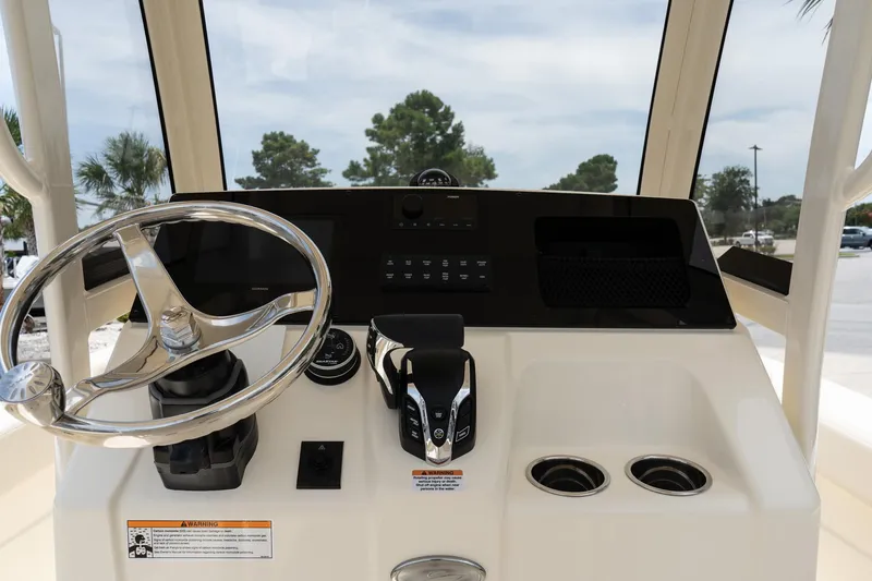 Slide: The Image of 2026 Scout 215 XSF boat dashboard with steering wheel and controls. - 9