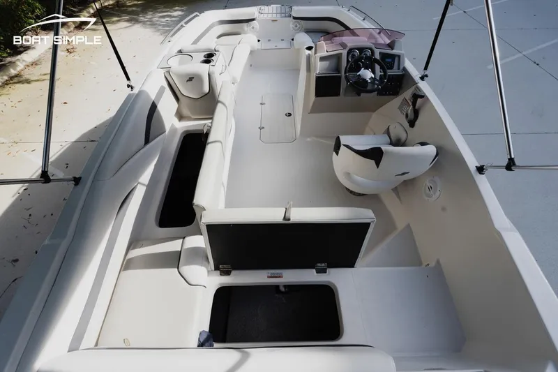 Slide: The Image of 2023 Starcraft SVX 211 OB boat interior with seating and steering console. - 7