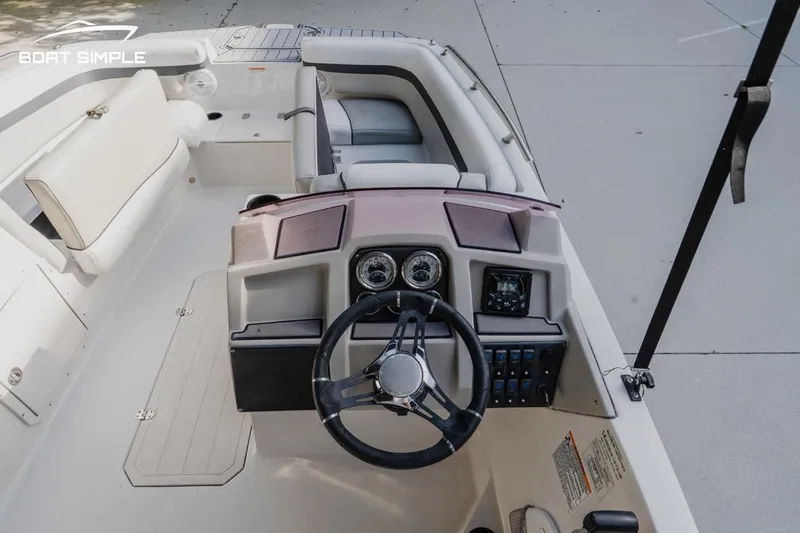 Slide: The Image of 2023 Starcraft SVX 211 OB boat interior with steering wheel and dashboard controls. - 8