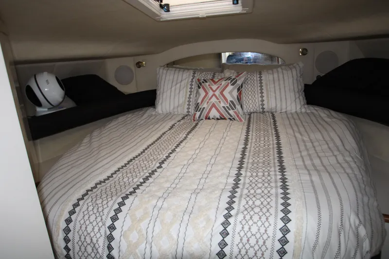 Slide: The Image of Interior of 1997 Sea Ray 400 Sundancer yacht with white seating and wooden flooring. - 10