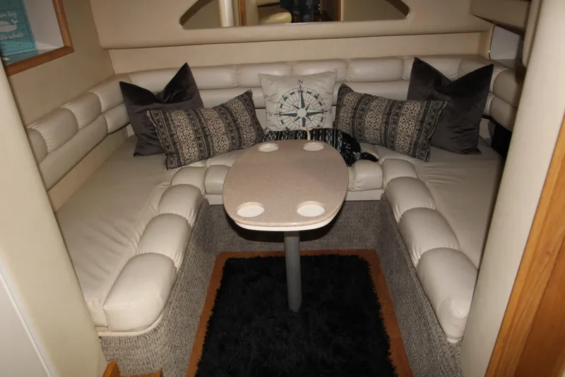 Slide: The Image of 1997 Sea Ray 400 Sundancer cabin with cozy bed and decorative pillows. - 11