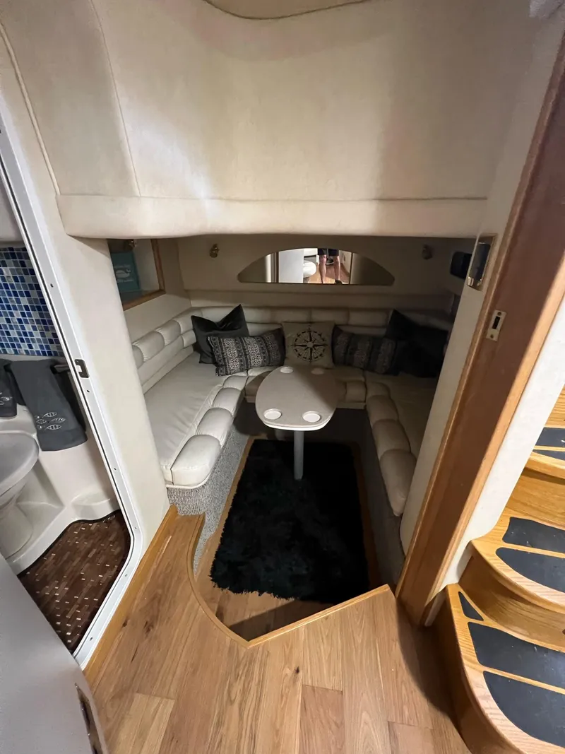Slide: The Image of Interior of 1997 Sea Ray 400 Sundancer with plush seating and decorative pillows. - 14