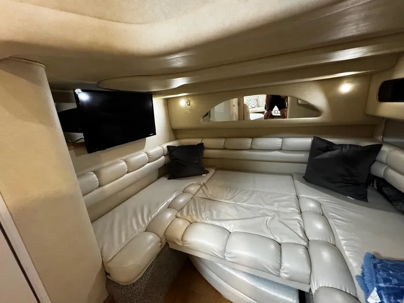Slide: The Image of Interior of 1997 Sea Ray 400 Sundancer yacht with cozy seating and wooden flooring. - 15
