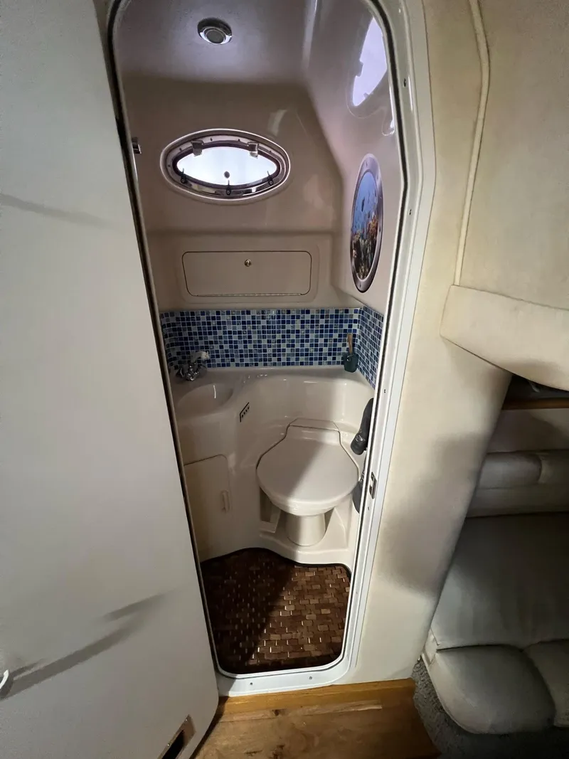 Slide: The Image of Stovetop in 1997 Sea Ray 400 Sundancer yacht kitchen, featuring three burners and sleek design. - 23