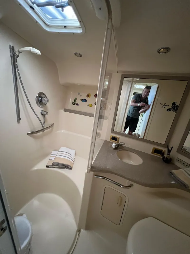 Slide: The Image of Bathroom interior of 1997 Sea Ray 400 Sundancer yacht, featuring sink and toilet. - 27