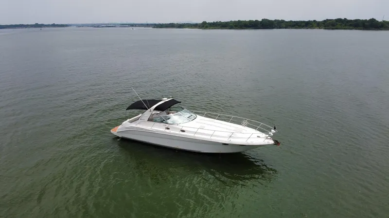 Slide: The Image of 1997 Sea Ray 400 Sundancer yacht on calm water, aerial view. - 3