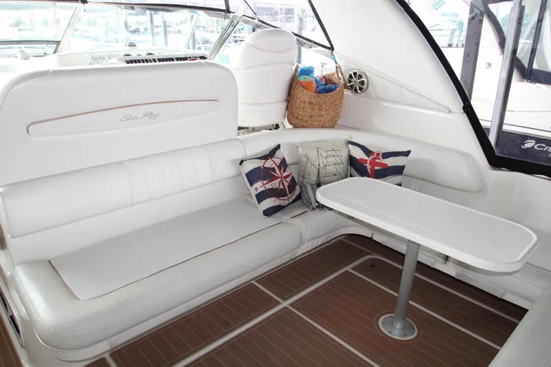 Slide: The Image of Interior view of 1997 Sea Ray 400 Sundancer yacht, showcasing cozy cabin and wooden flooring. - 31