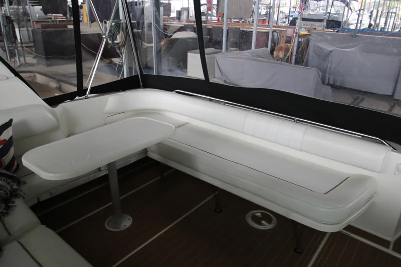 Slide: The Image of Luxurious interior of a 1997 Sea Ray 400 Sundancer yacht with white seating and wood flooring. - 35