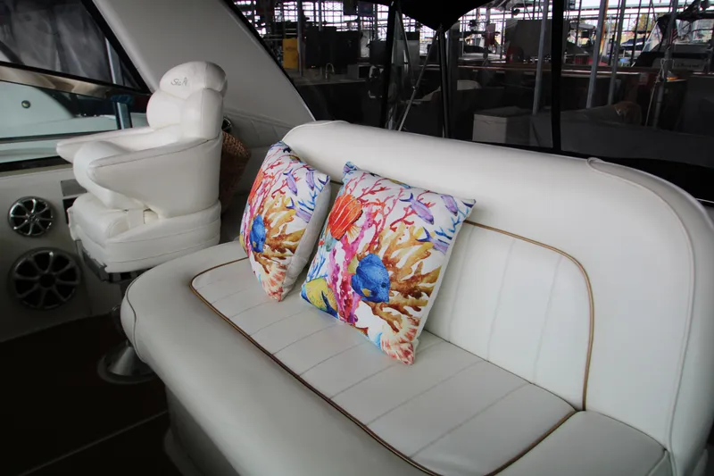 Slide: The Image of 1997 Sea Ray 400 Sundancer interior with white seating and table, showcasing luxury yacht design. - 36