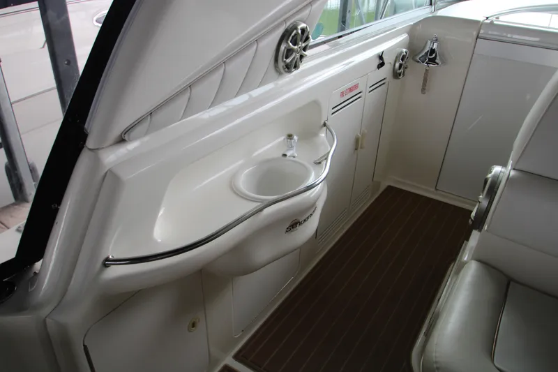 Slide: The Image of 1997 Sea Ray 400 Sundancer interior with sink and wooden flooring. - 38