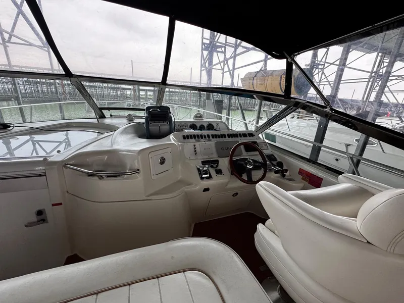 Slide: The Image of 1997 Sea Ray 400 Sundancer helm with Garmin navigation and wood steering wheel. - 43