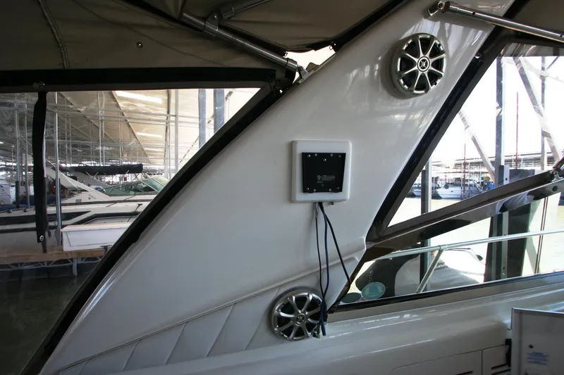 Slide: The Image of 1997 Sea Ray 400 Sundancer helm with gauges and controls in a marina setting. - 45