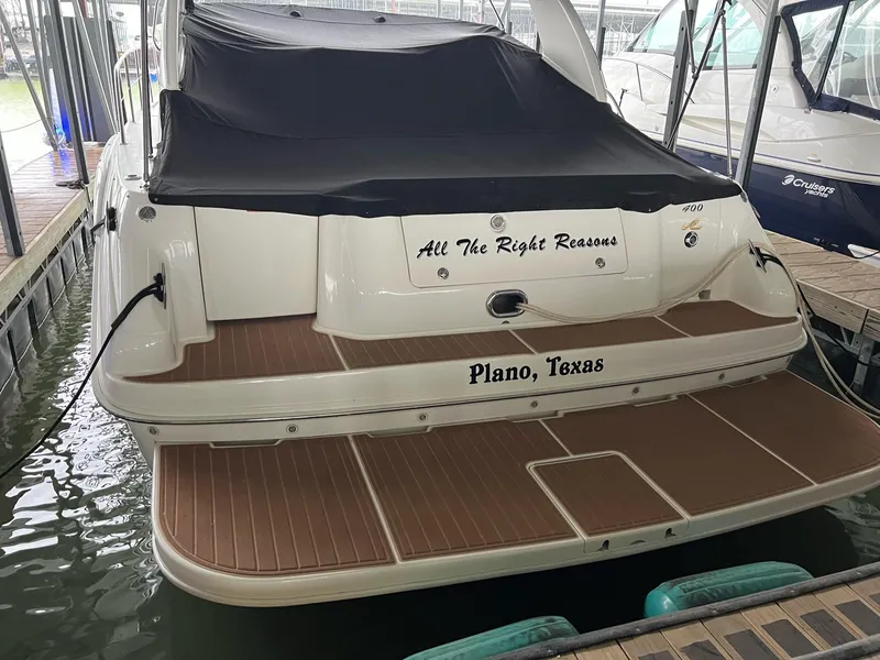 Slide: The Image of 1997 Sea Ray 400 Sundancer yacht docked at marina, showcasing sleek deck design. - 48