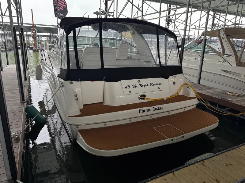 Slide: The Image of 1997 Sea Ray 400 Sundancer docked, rear view, with "All The Right Reasons" and "Plano, Texas" text. - 49