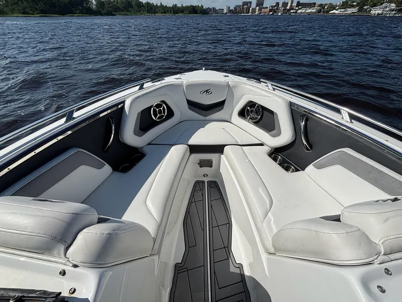 Slide: The Image of 2016 Monterey 238 Super Sport boat interior with white seating on a lake. - 12