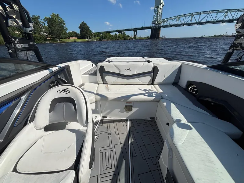 Slide: The Image of 2016 Monterey 238 Super Sport boat interior with seating, on a river near a bridge. - 6