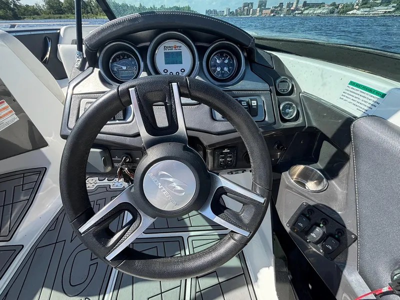 Slide: The Image of Steering wheel and dashboard of 2016 Monterey 238 Super Sport boat on water. - 8