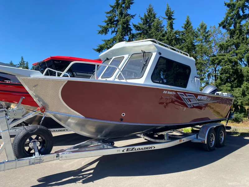 The Image of 2025 Hewescraft 240 Ocean Pro ET HT boat on trailer, parked outdoors. - 1