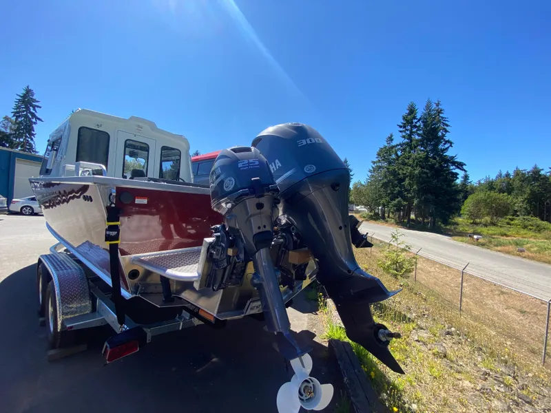 Slide: The Image of 2025 Hewescraft 240 Ocean Pro ET HT boat with dual Yamaha outboard motors. - 3