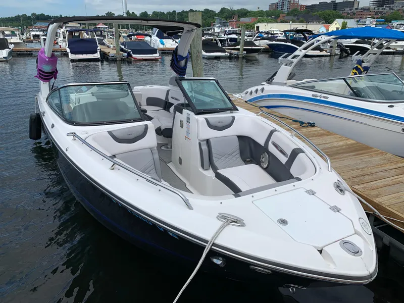 Slide: The Image of 2019 Chaparral 257 SSX boat docked at marina, featuring sleek design and spacious seating. - 20