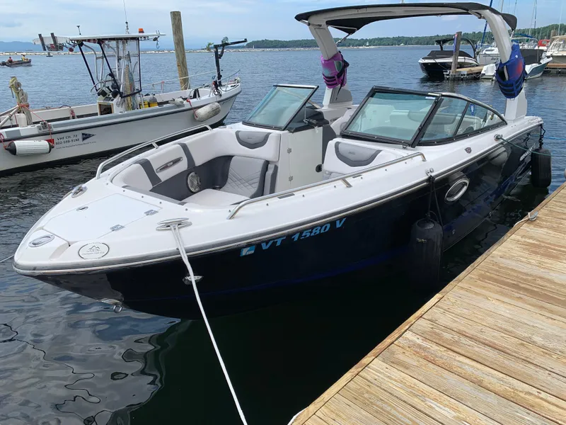 Slide: The Image of 2019 Chaparral 257 SSX boat docked at a marina, featuring sleek design and spacious seating. - 21