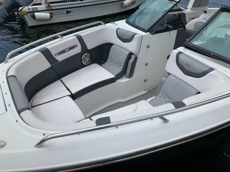 Slide: The Image of 2019 Chaparral 257 SSX boat interior with white and gray seating. - 22