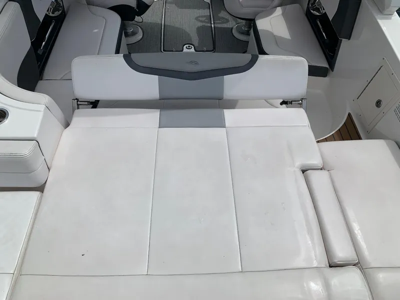 Slide: The Image of 2019 Chaparral 257 SSX boat interior with white cushioned seating and sleek design. - 27