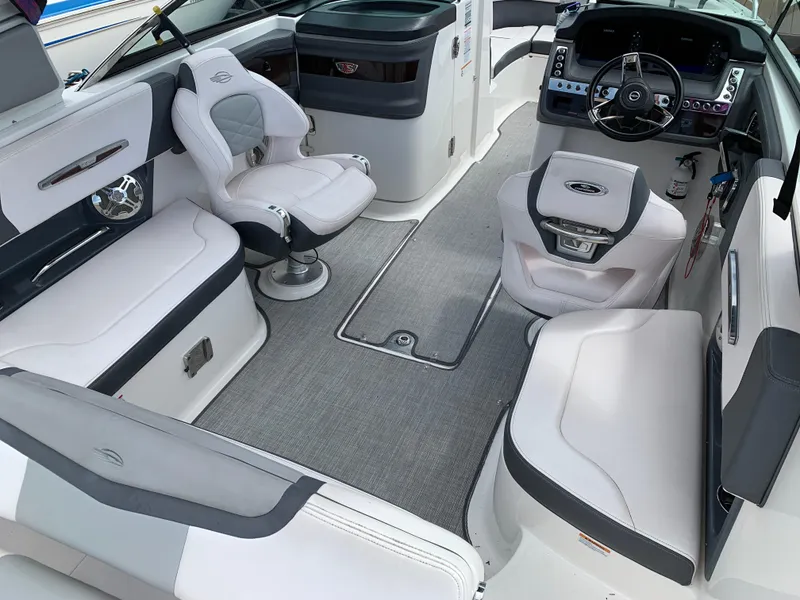 Slide: The Image of 2019 Chaparral 257 SSX boat interior with modern seating and sleek dashboard design. - 28