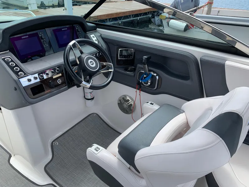 Slide: The Image of 2019 Chaparral 257 SSX boat cockpit with steering wheel and dual displays. - 29