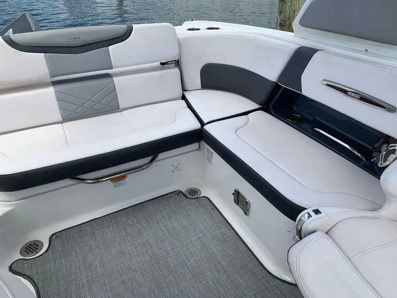 Slide: The Image of Luxurious seating area on a 2019 Chaparral 257 SSX boat, featuring elegant upholstery. - 36