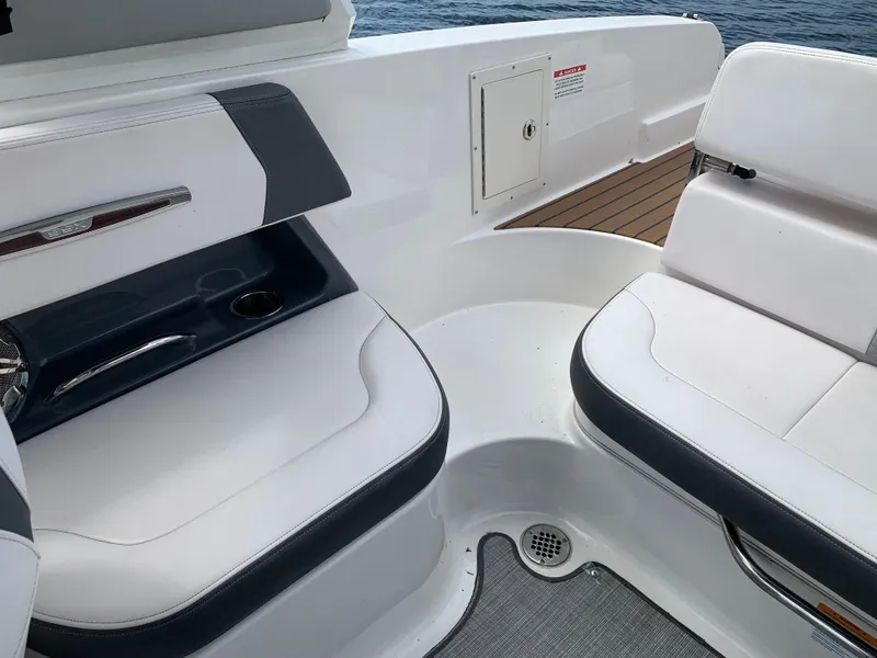 Slide: The Image of 2019 Chaparral 257 SSX boat interior with white seating and cup holder. - 37